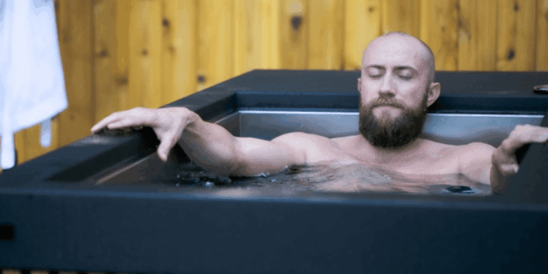 man-sitting-in-a-cold-plunge